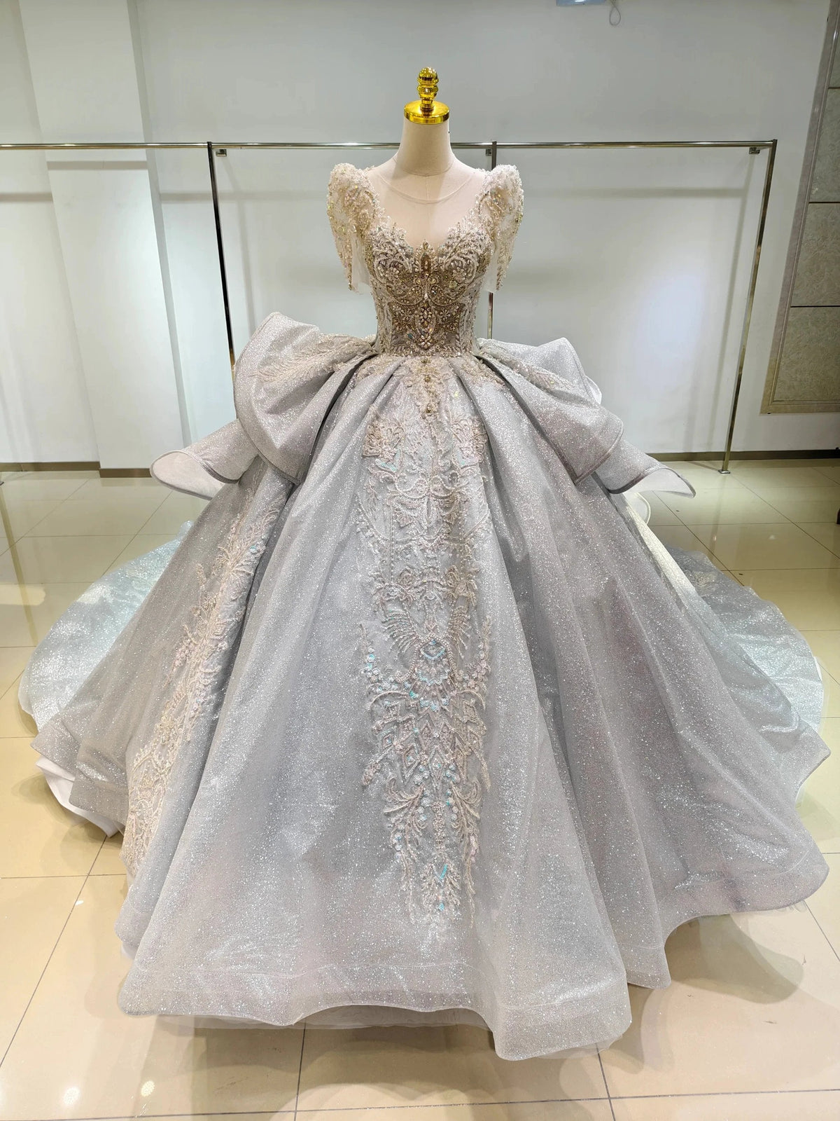 Silver Glimmer V-Neck Ballgown: Crystal-Embroidered Bust & Dramatic Bow Train by ZAPDRESS